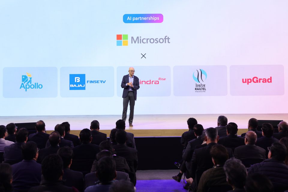 Person on stage, speaking at Microsoft event