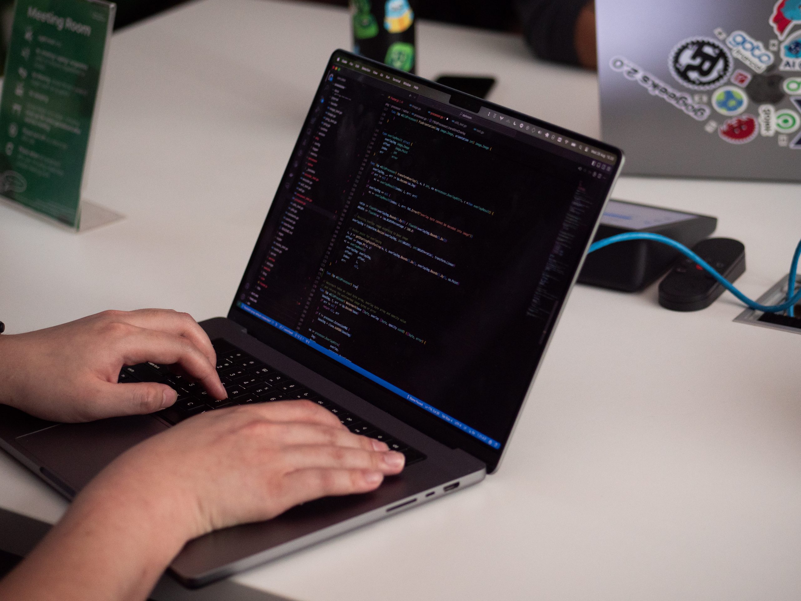 hands typing on a laptop with its screen showing GitHub Copilot platform