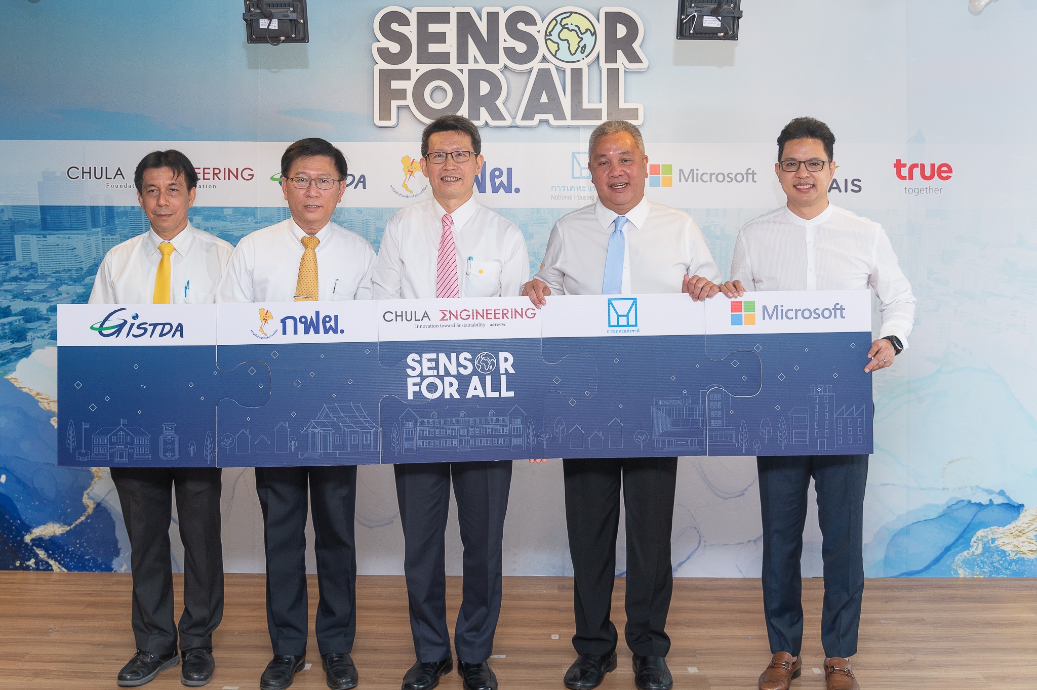 Five men holding five connected signs for Sensor for All project