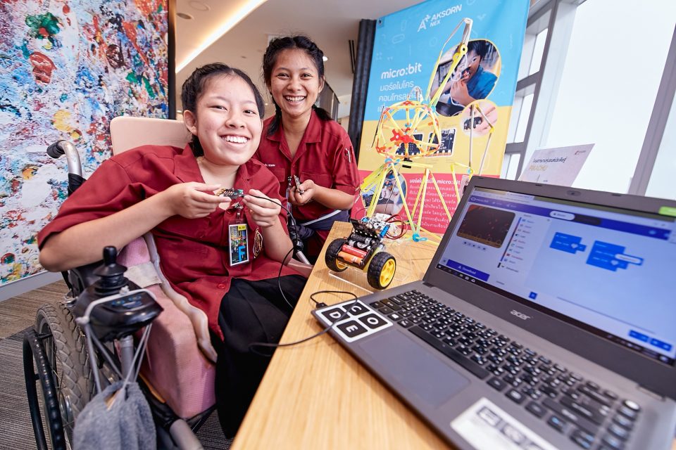 Two female students in front of a laptop