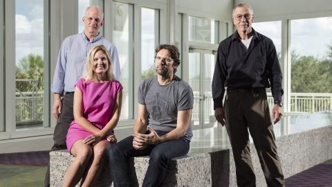 Charles Marcus, Krysta Svore, Leo Kouwenhoven and Michael Freedman staring at the camera in the office lobby