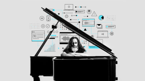 Matthew Bennett sits at a grand piano with graphics behind him
