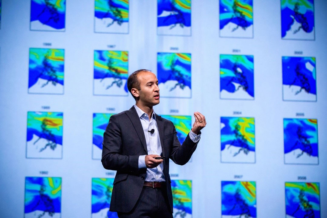 Man wearing dark suit doing a presentation