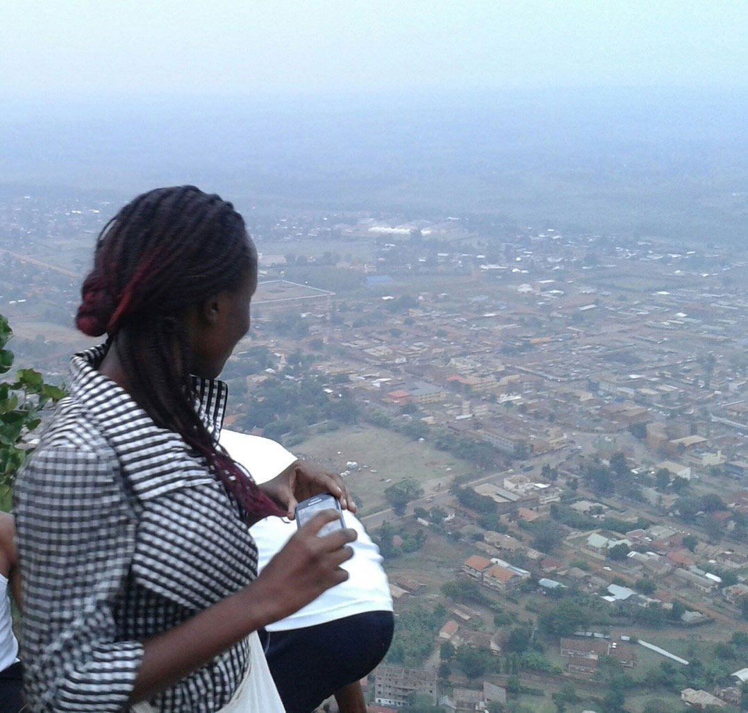 Woman looking down on city from elevated position