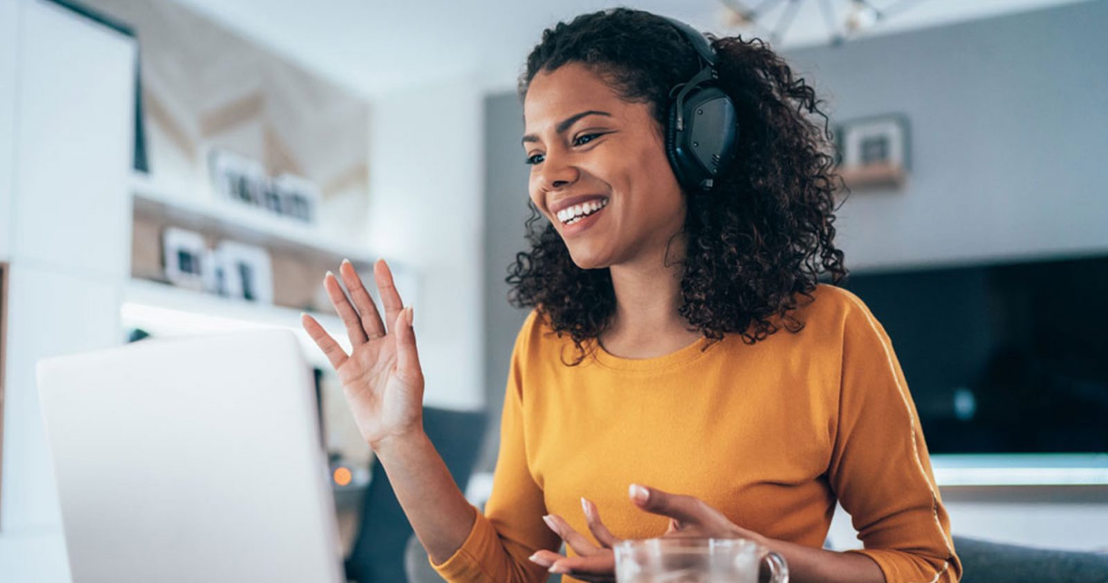 Young female profession talks animatedly on a conference call as she works from home.