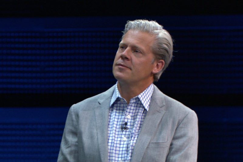 A man stands on stage speaking