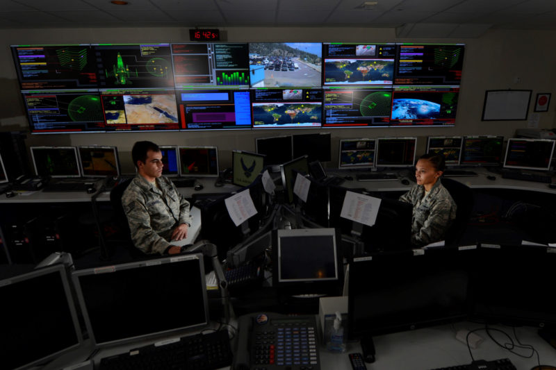 military personnel working at computers