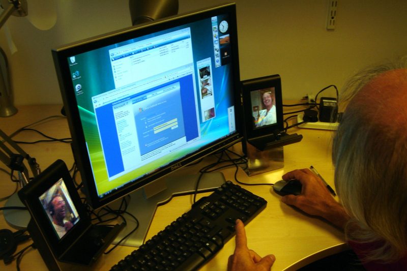 Man uses computer and two devices