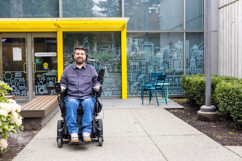 Person outside in front of the Inclusive Tech Lab; smiling