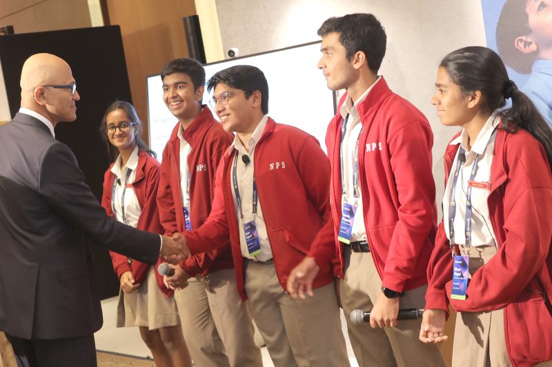 a man interacting with school children