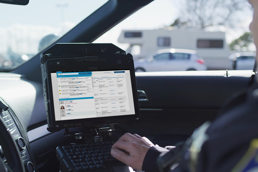 Police man using computer in his car