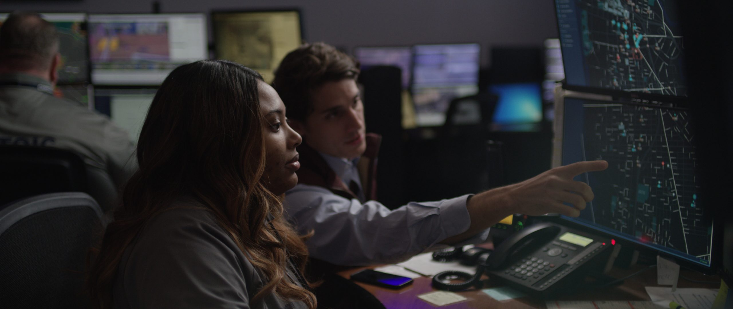 Stock imagery of two officers looking at police map