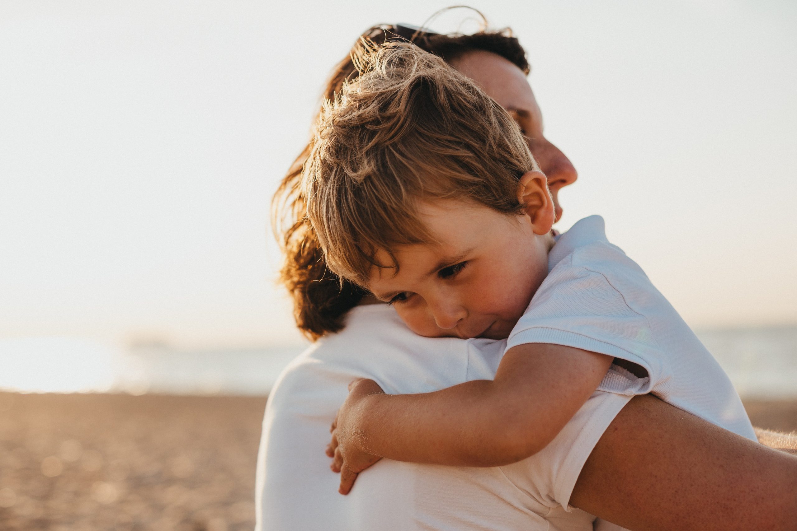 Happy child hugging mother