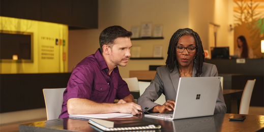 Financial analyst helping a customer on a Surface laptop