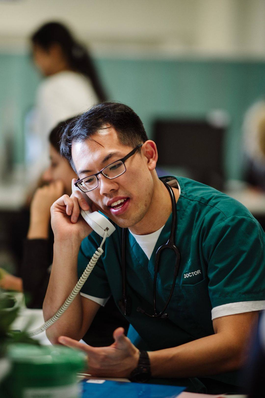 Doctor talking to patients through the hospital phone