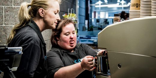 Worker with disability making a cup of coffee