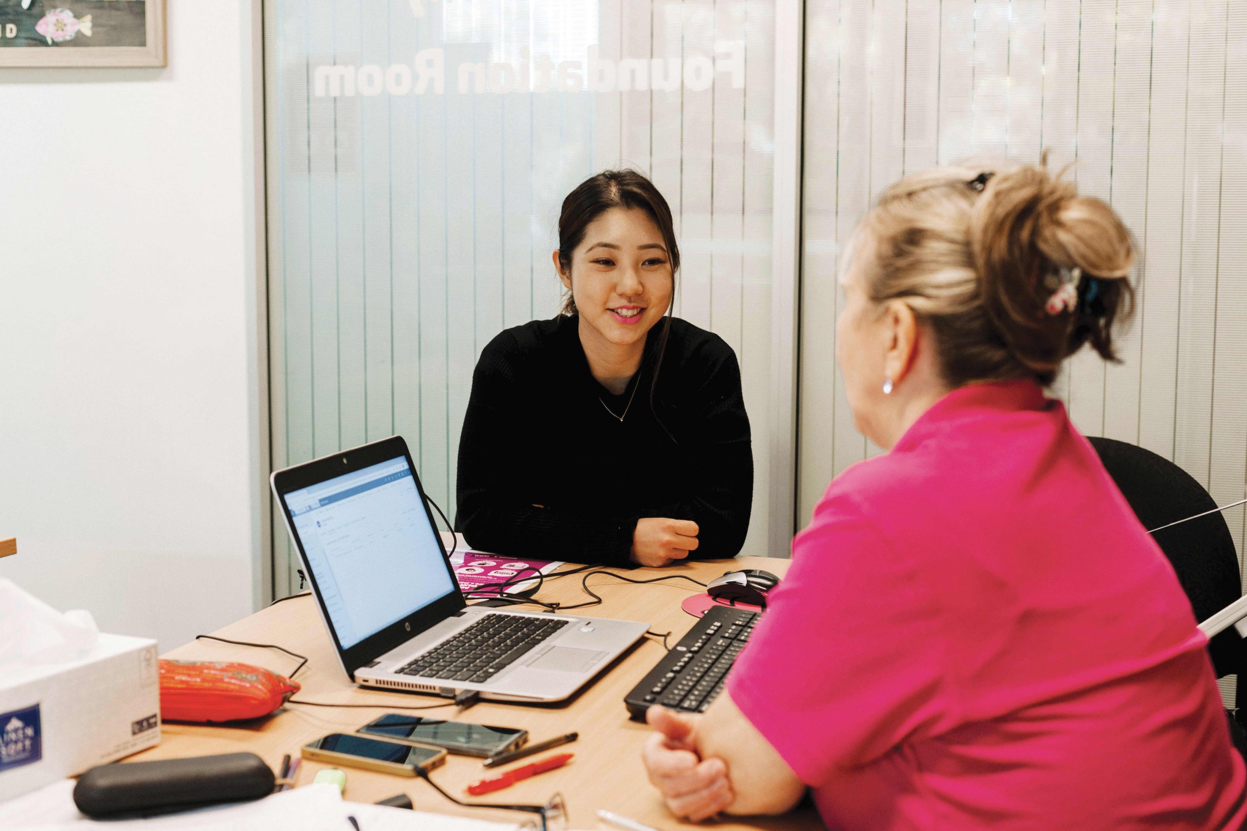 Staff providing advice to client in office