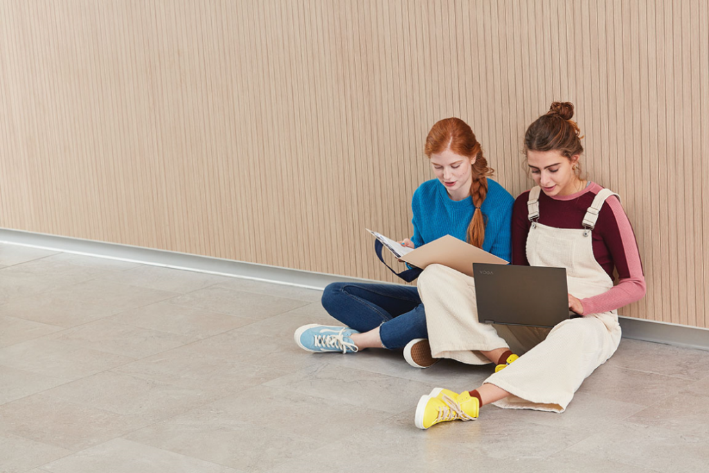 Female students sitting down with their laptops