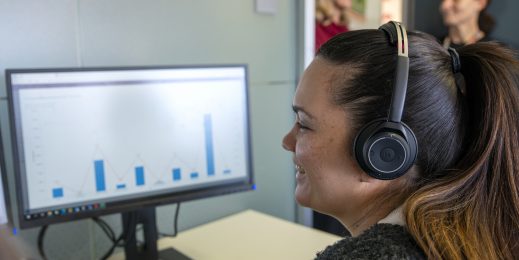 Call centre service member taking a call via her computer