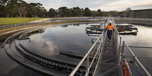 Worker in safety workwear inspecting a water system