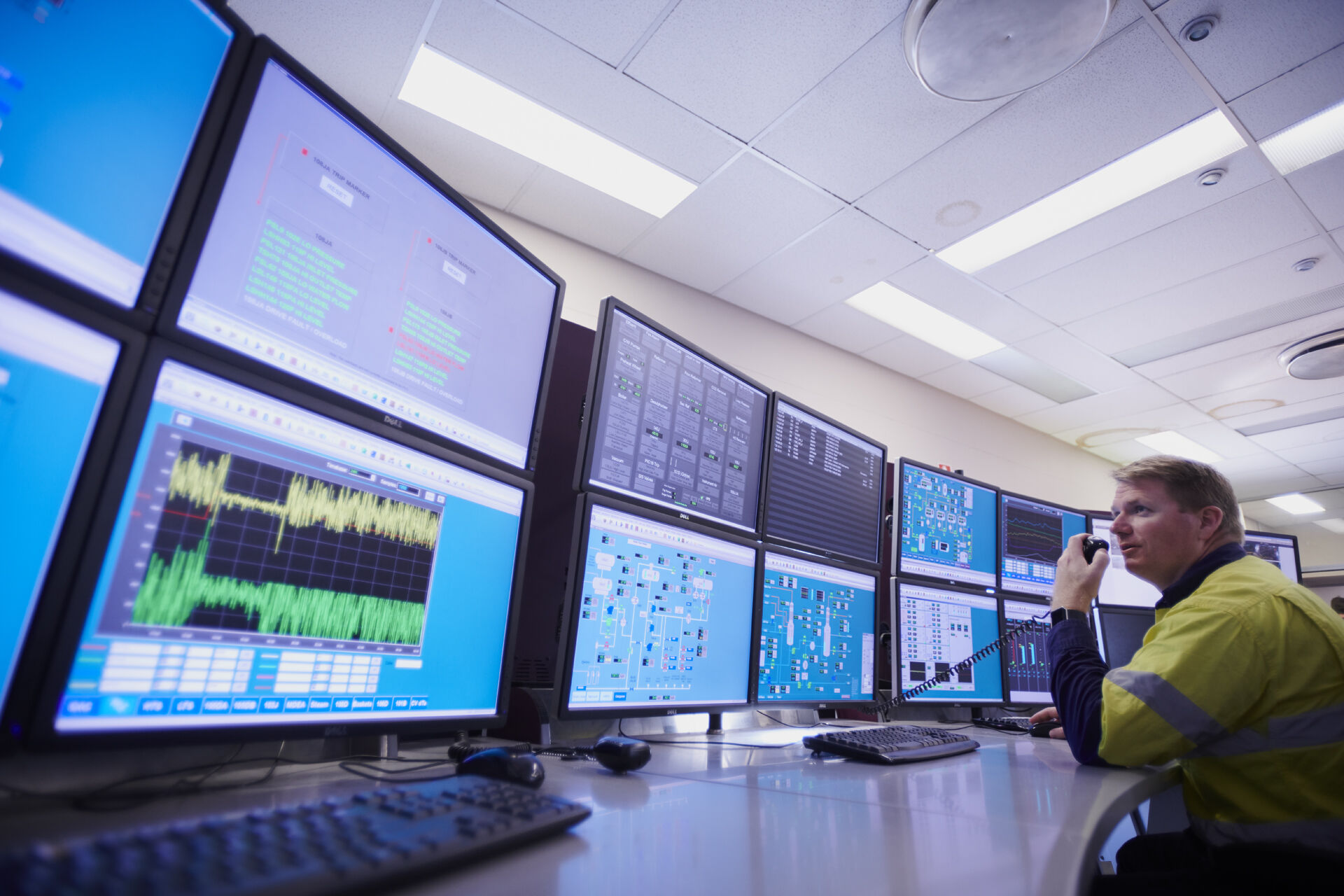 Orica employee working with several desktop screens