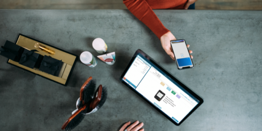 Birds eye view of a cafe service desk using a phone as payment