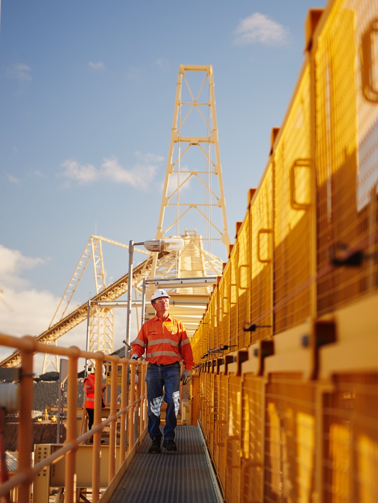 Man in safety clothing inspecting a mining building