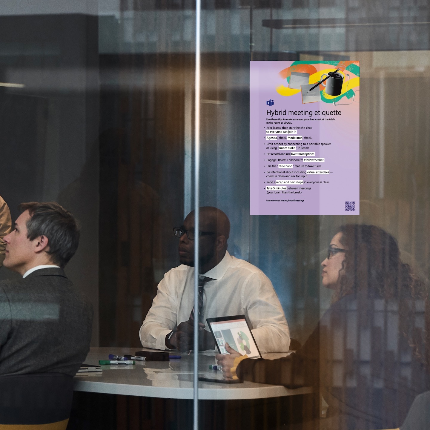 Three adults sitting in a meeting room