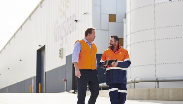 Two adult men wearing safety clothing