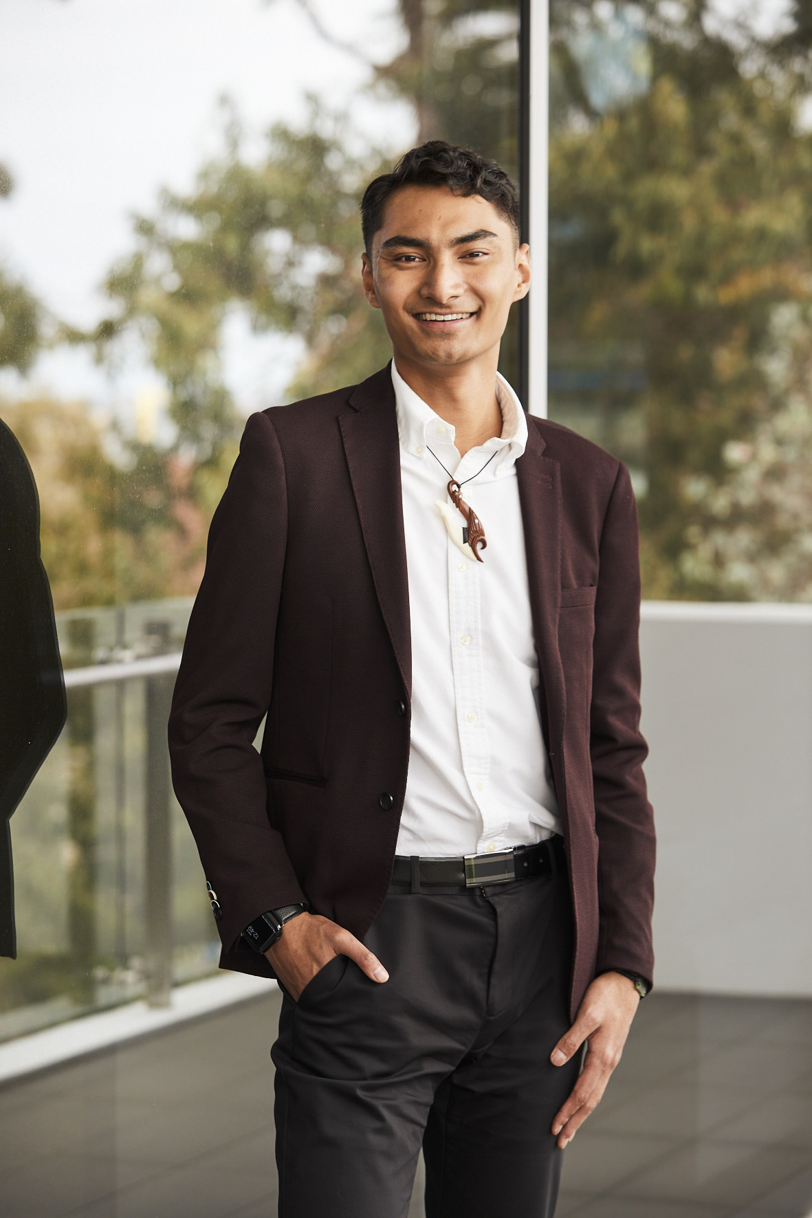 Isaac Morunga, adult male, dressed in a brown blazer, white shirt and black pants