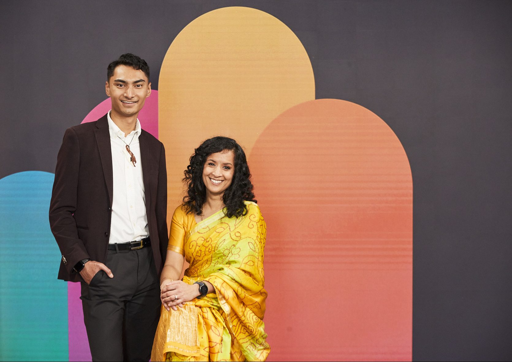 Adult male in a suit and an adult female in a traditional sari dress