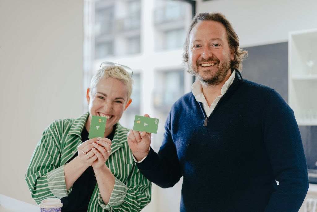 Two adults holding a Thriday debit card