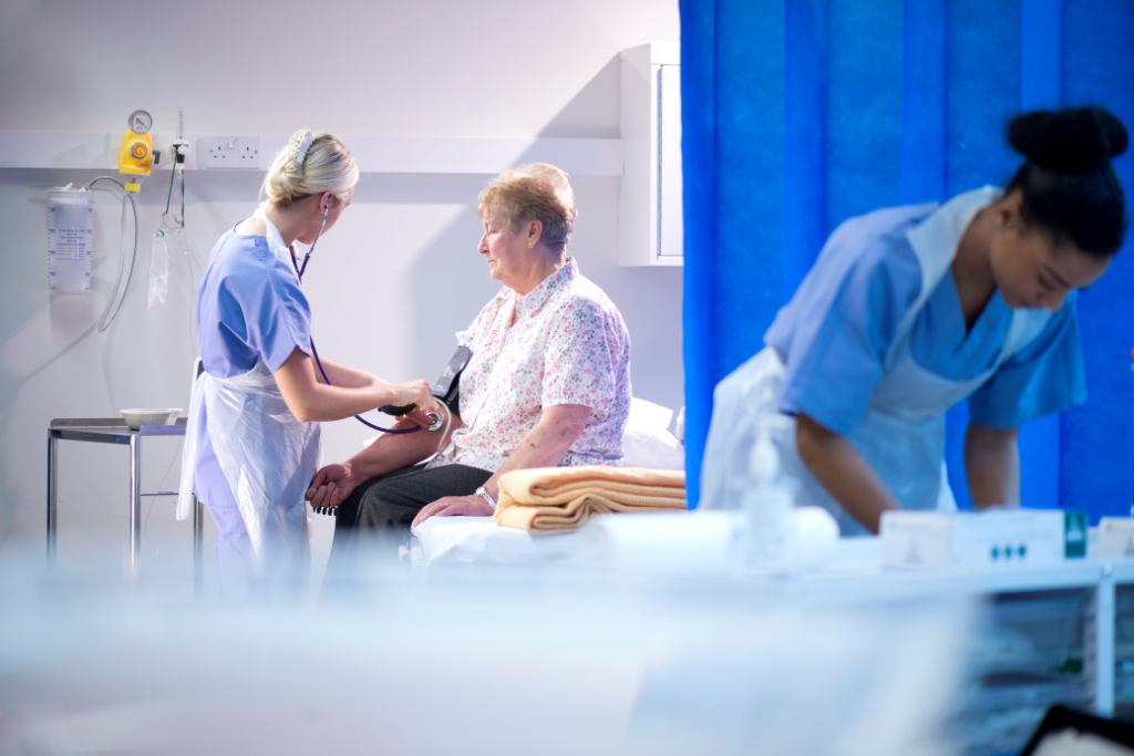 Elderly woman getting medically assessed in a hospital.