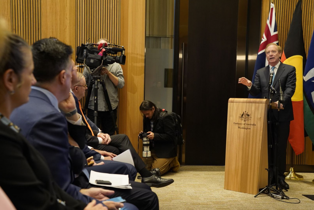 Brad Smith (standing right) addressing press in a conference at the Embassy of Australia at Washington, DC