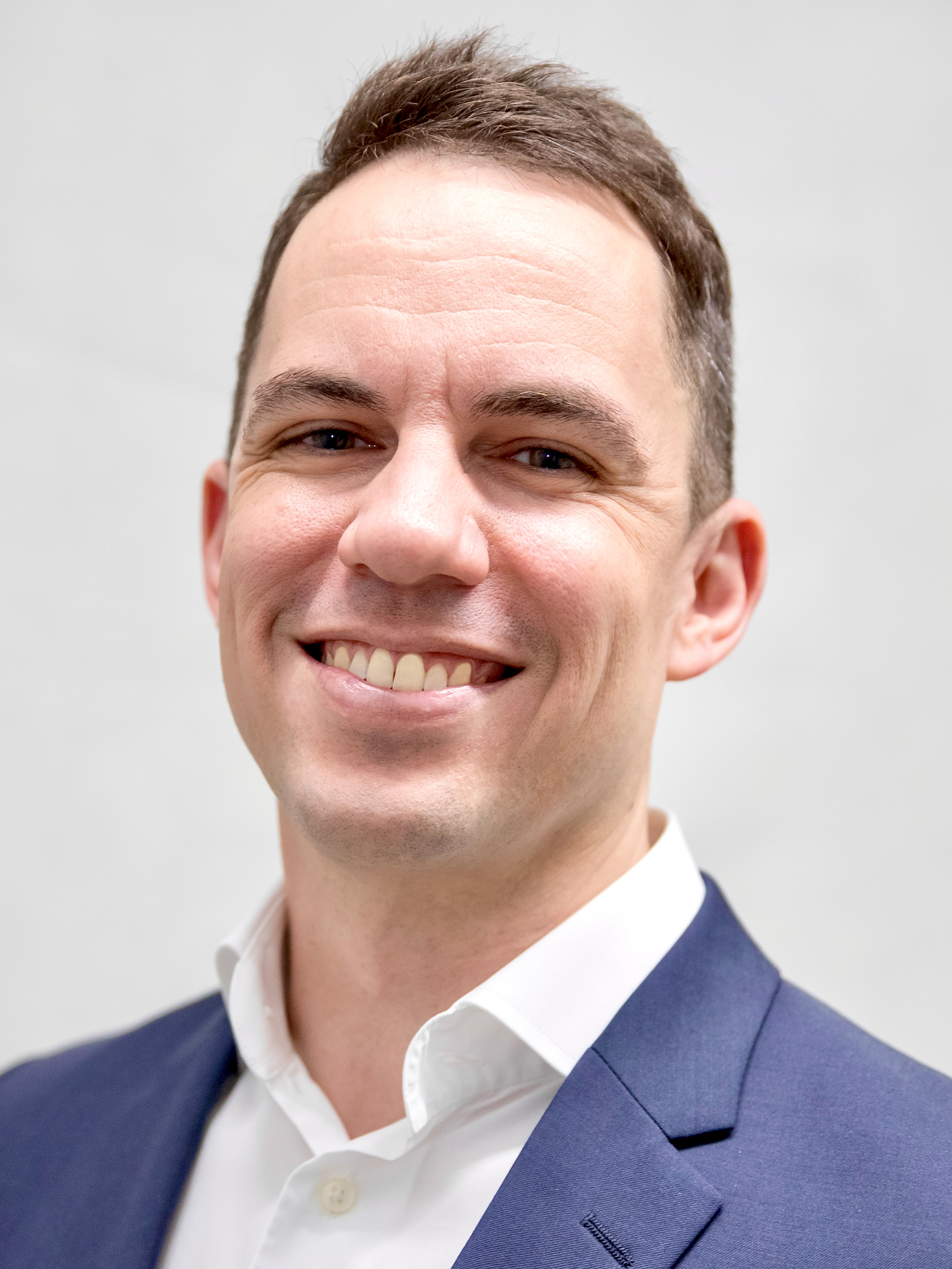 Headshot of a Caucasian adult male in a business suit 