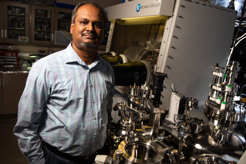 A material sciences group lead stands in a lab