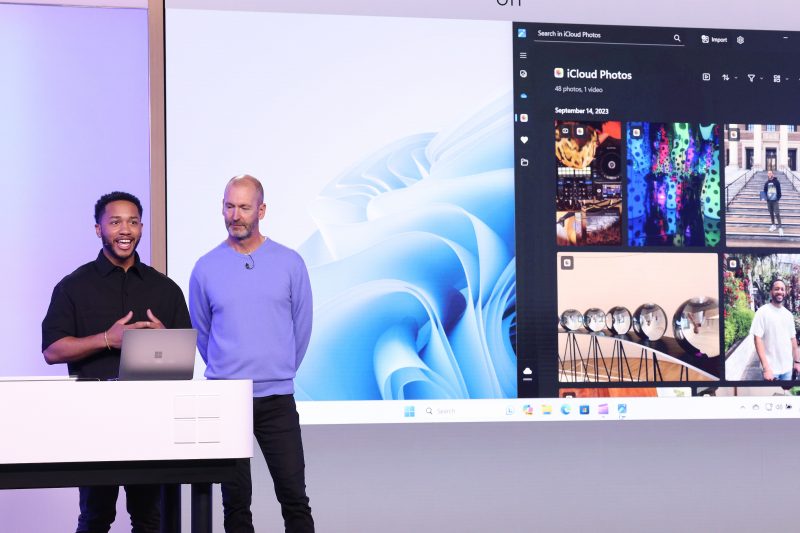 Image of Brett Ostrum, Microsoft corporate vice president for Surface devices, speaking on stage with Nicholas Albert, a Microsoft product marketing manager.