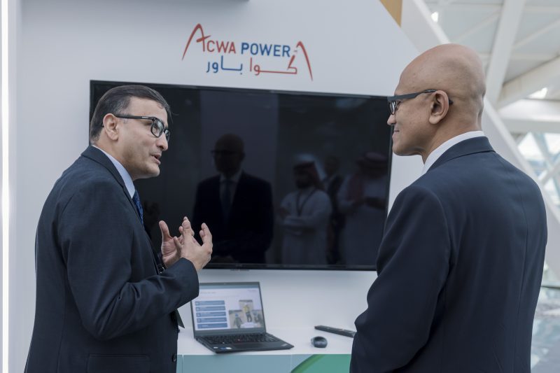 Two men wearing business suits in a conversation