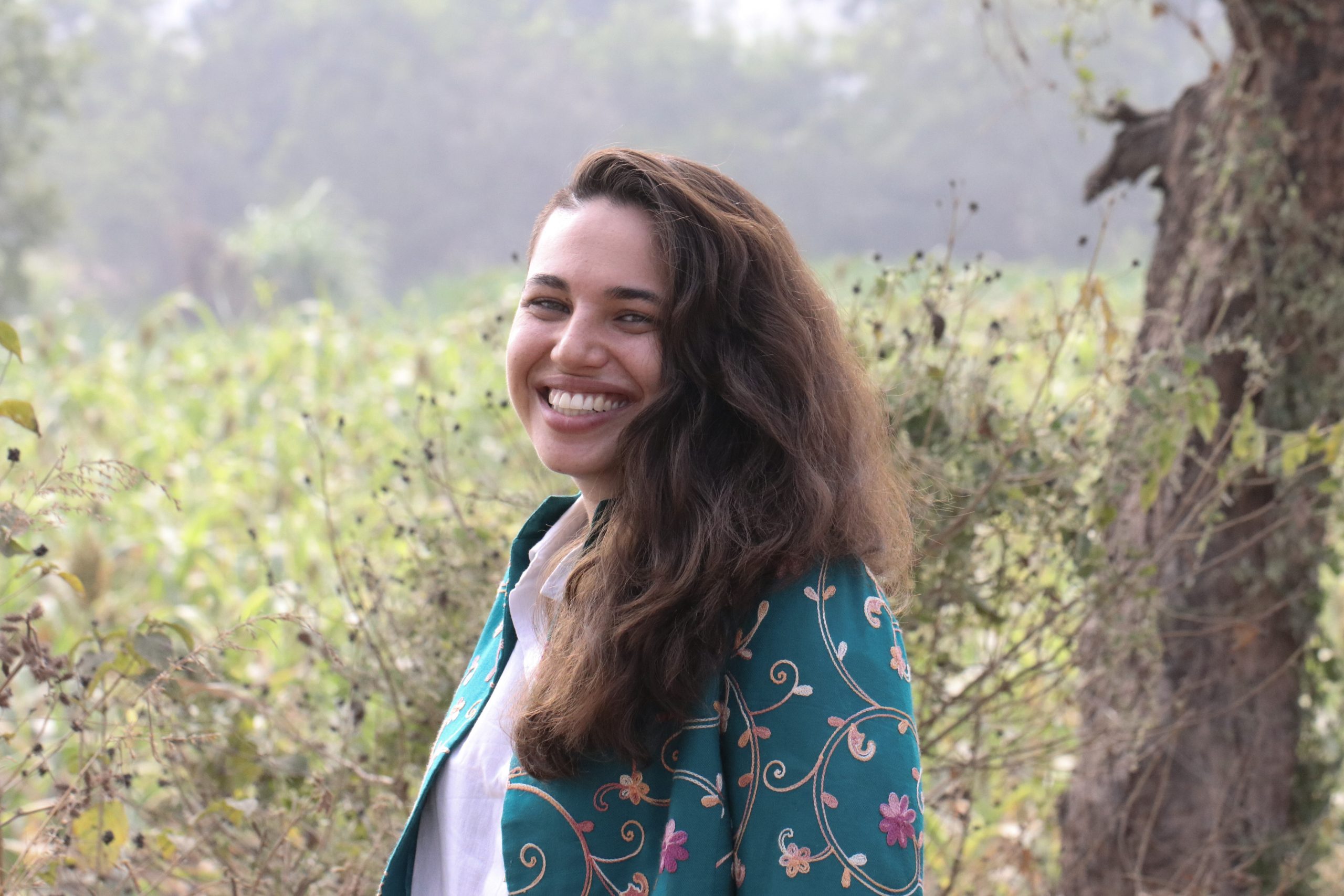 Outside portrait of a girl smiling in a field