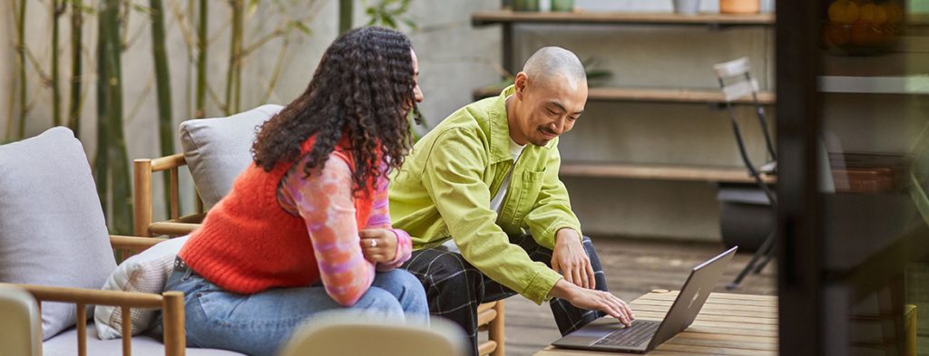 Two people looking at a computer