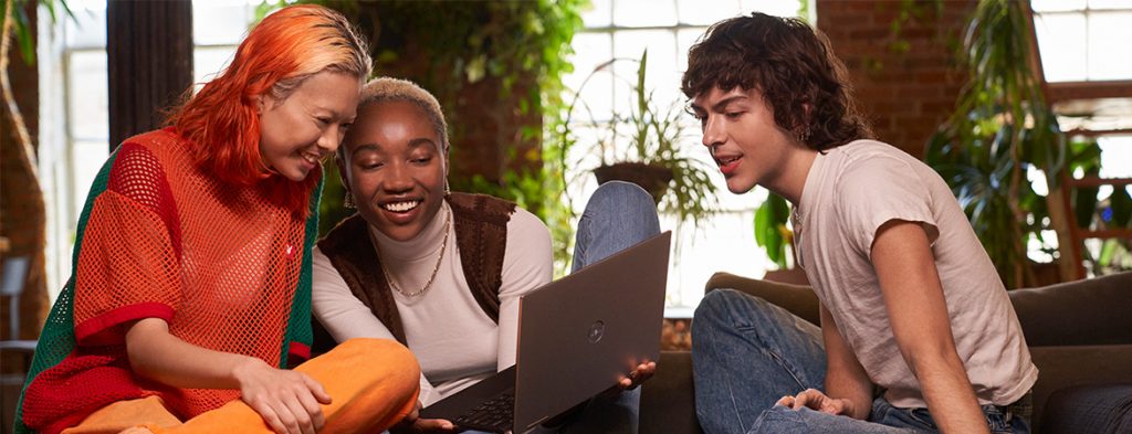 A group of people looking at a computer