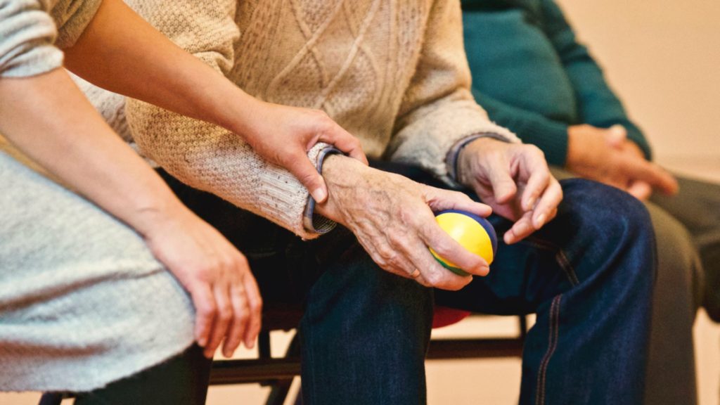 Two people's hands on top of each other