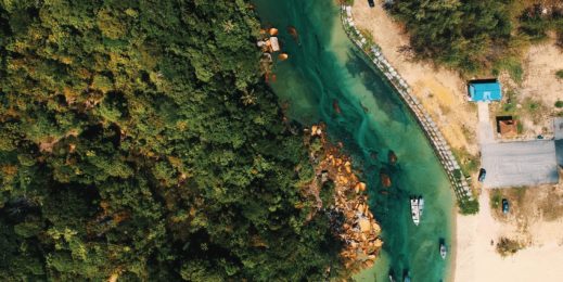 Aerial shot of a river and boats from above